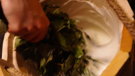 preparing a traditional sauna treatment with birch branches