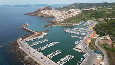 castelsardo harbor and fortified town in sardinia, italy - 4k drone aerial forward