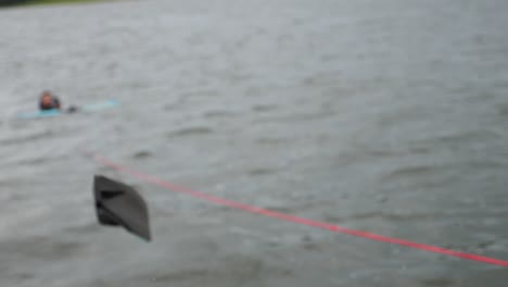 someone throws skis into the lake in preparation to water ski