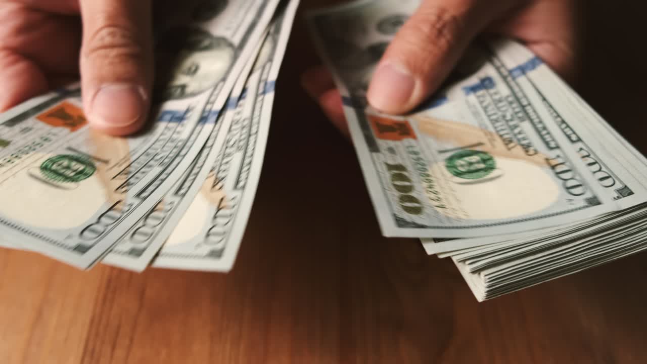 Male hands counting us dollar bills. Income and Business concept.