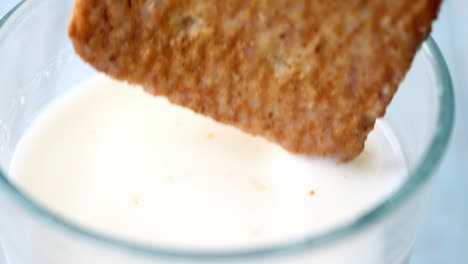 dipping a cracker in milk