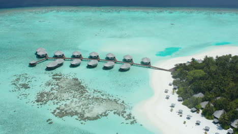 aerial view of overwater bungalows on private resort kihaa maldives