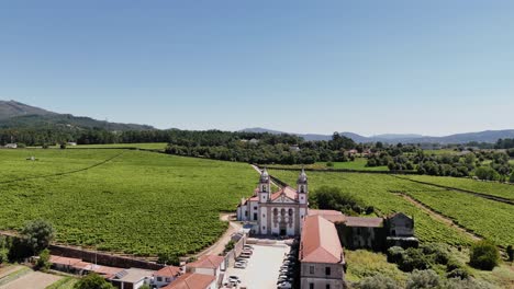 mosteiro de rendufe surrounded by vast green vineyards in amares minho portugal - aerial