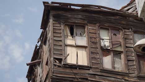close-up of a dilapidated wooden building with broken windows