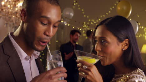 couple make toast as they celebrate at party together