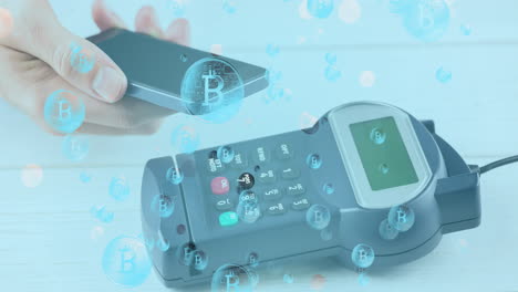 animation of bitcoins over smartphone and payment terminal