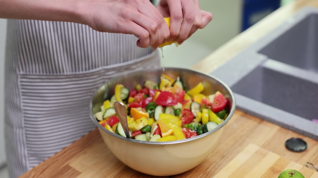 Preparing a fresh salad with lemon juice