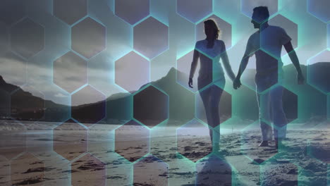 Walking on beach, couple with animation of hexagonal pattern overlaying scene