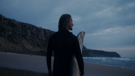 surfer on beach at sunset