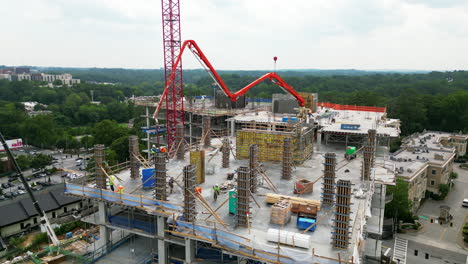 Aerial-ascending-footage-of-workers-casting-concrete-columns-to-framework