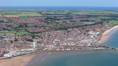 High-angle-drone-footage-of-Bridlington-in-summer-with-blue-sky-and-ocean