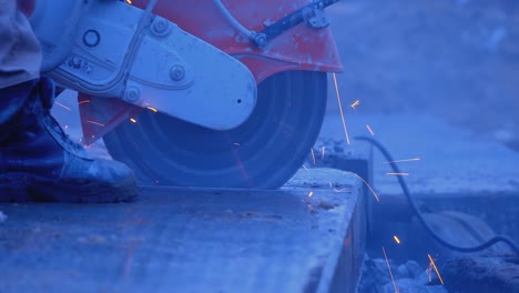 a builder by grinder cuts off part of a thick slab, a lot of sparks and smoke