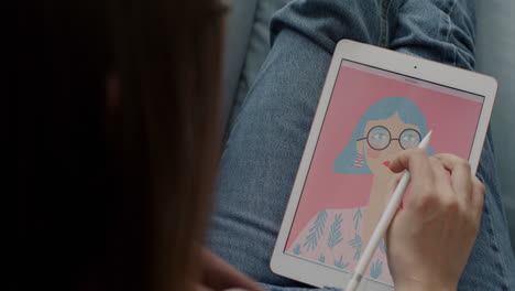 Woman drawing a digital portrait on an iPad