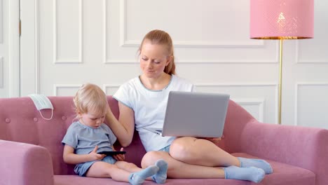 mother working from home with toddler