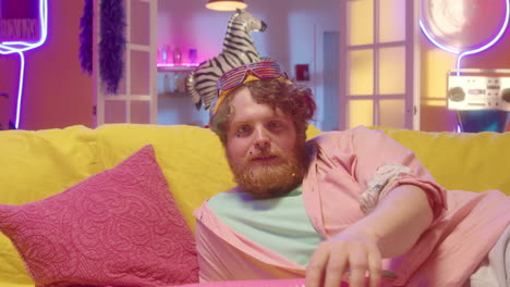 man relaxing on a couch with popcorn and retro style