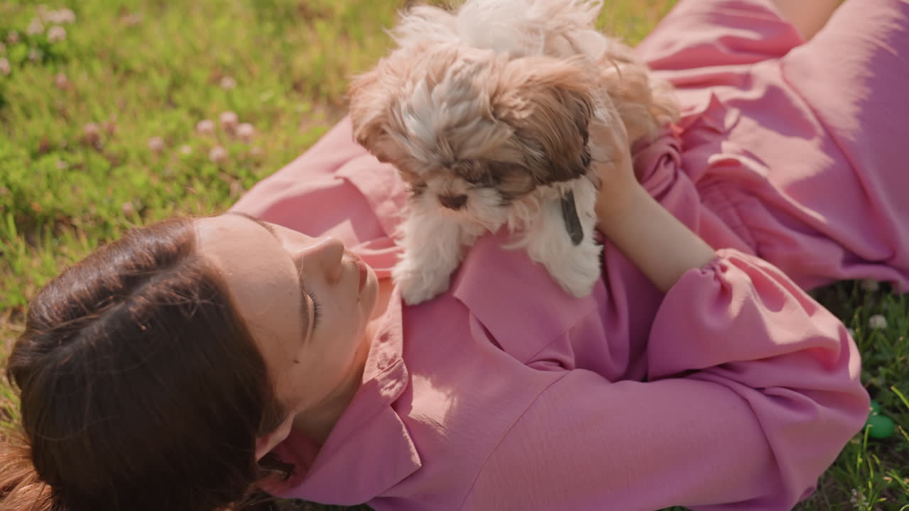Woman Cuddling Puppy, Calm Lady Relaxing With Small Dog, Gentle Woman Resting Peacefully With Tiny Puppy Close, Woman Gently Snuggles With Puppy As She Relaxes Peacefully Outdoors In Nature