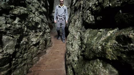 man walking through pokljuka gorge in slovenia during spring in the triglav national park-17