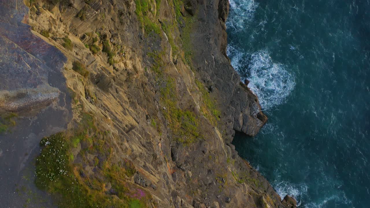Vertiginous glide over the edge of Cliffs of Moher from high above