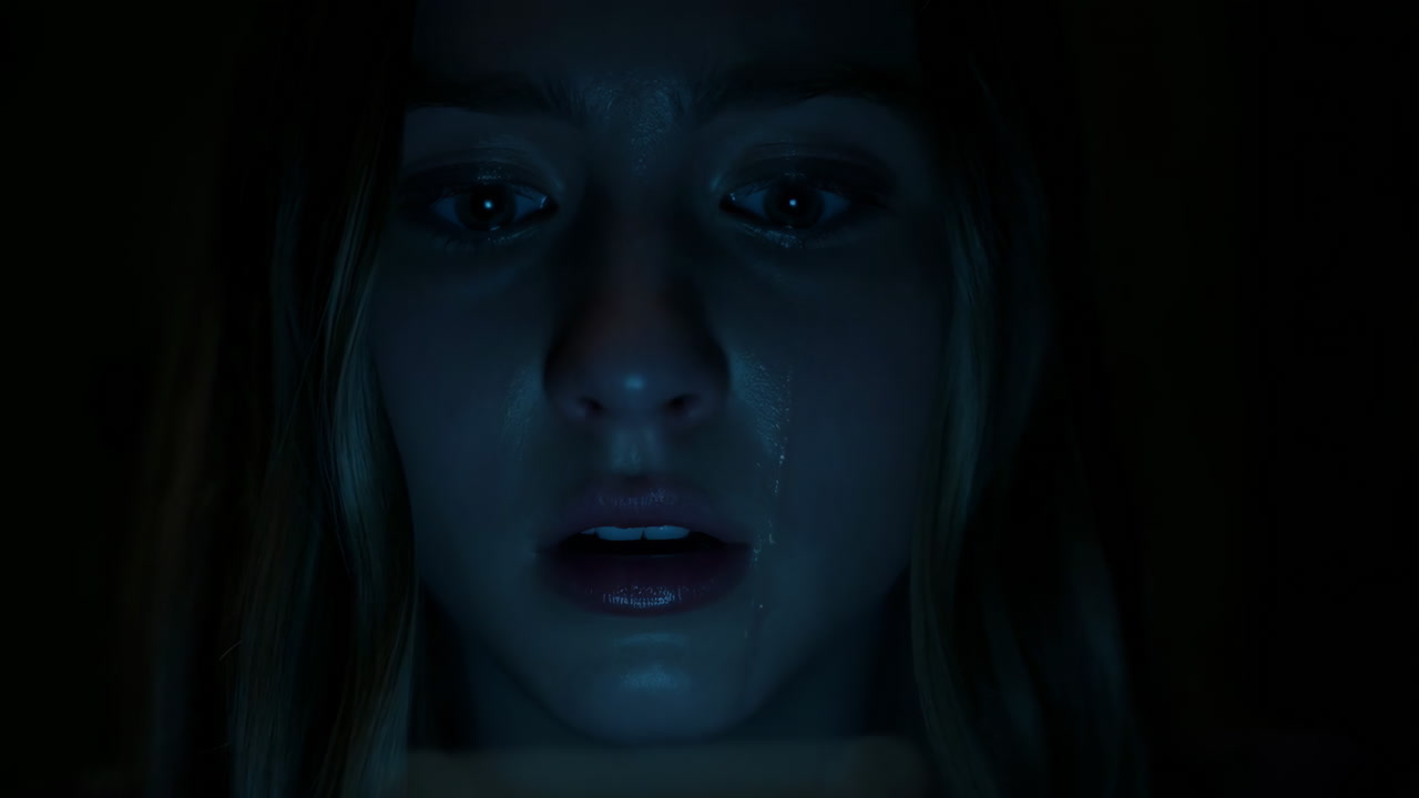 Frightened Woman Illuminated by Screen Light