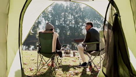 couple, camping and back with tent