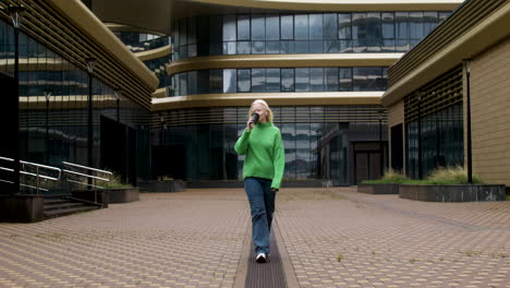 happy woman holding coffee cup outdoors