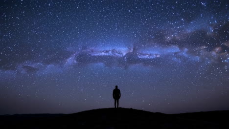 silhouette of a man under a starry night sky