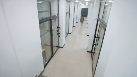 people walking through a bright modern office corridor
