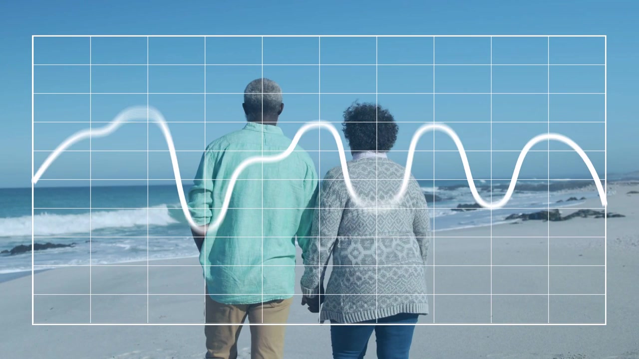 Senior couple walking along sandy shore holding hands initiating waveform grid showing heart data