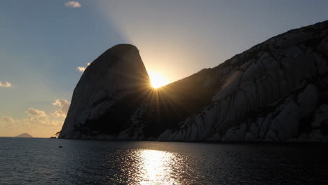 sunset over rocky island