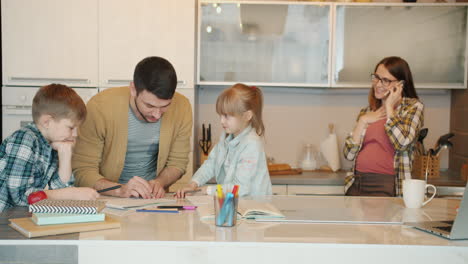 family doing homework together in kitchen