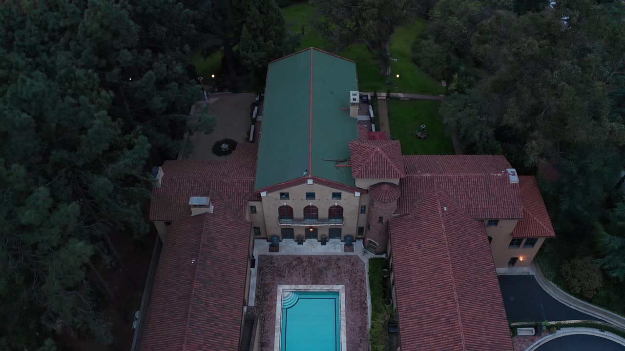 Close-up descending and tilting up shot of the elegant Paramour Estate during low light in Los Angeles, California. 4K