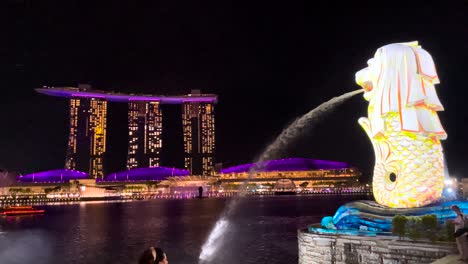 singapore merlion fountain in cityscape illuminated at night