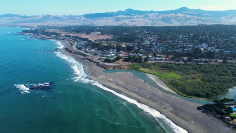 drone aerial landscape view of cambria main town california coastline sandy beach headland seaside village with forest mountain range region usa america travel tourism