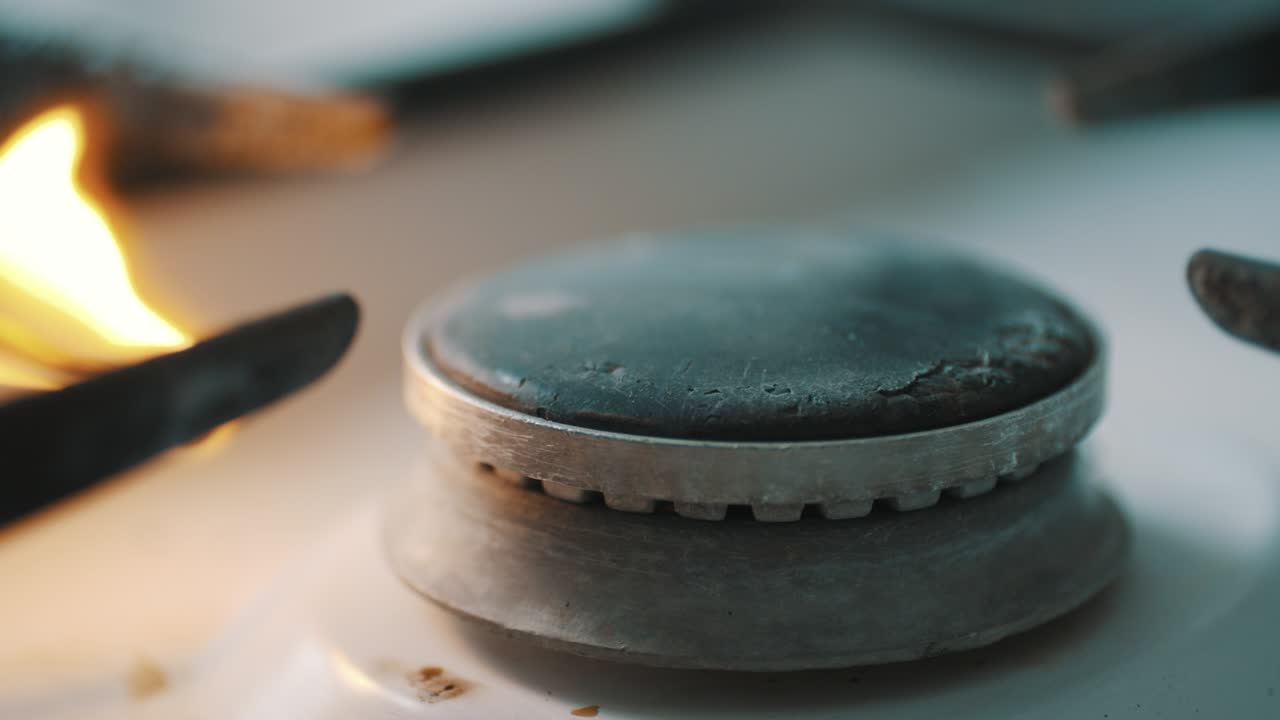 스토브 버너가 파란색 요리 불꽃으로 불타고 있습니다.