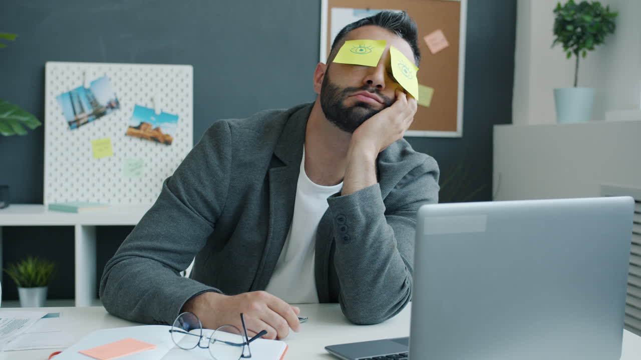 Bored and Sleepy Businessman at His Desk