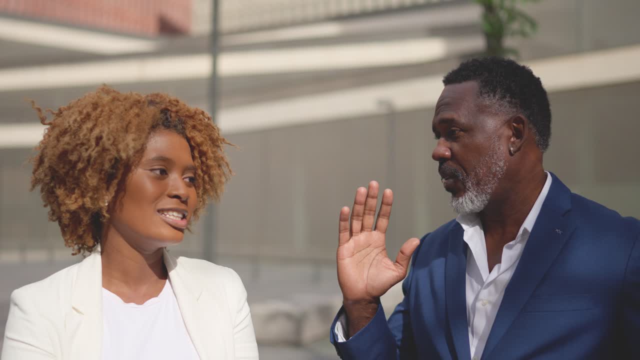 Two professionals in conversation outdoors