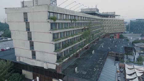 Aerial-Drone-Shot-Krakow-Poland-Abandoned-Soviet-Brutalist-Structure-Hala-Forum-at-Sunrise