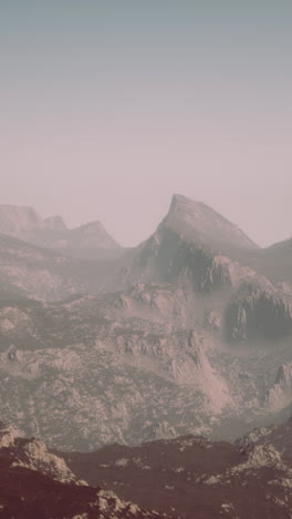 misty mountain range in a barren landscape