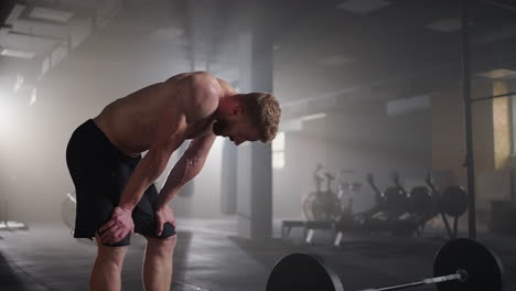 preparing for the exercise training. fitness man athlete chalk powder sportsman preparing training workout in gym ready for bodybuilding strength exercise slow motion.