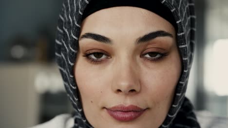 young muslim woman looking at camera