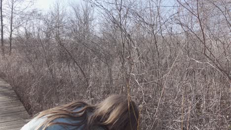 portrait of a little girl on vacation holiday explores at crosswinds marsh, wayne county michigan, pure michigan