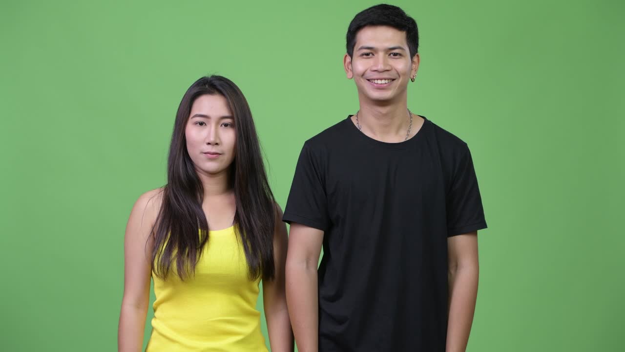 Young Asian couple clapping hands together