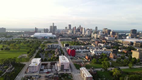 brewster douglas neighborhood during a sunny nice day surrounded by urban sky scrapers and green park, aerial forwarding establishing shot