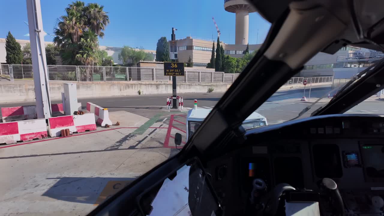 An immersive cockpit view of a push-back maneuver as seen by the pilot, in a sunnyn day with a blue sky