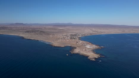 Aerial-dolly-over-Bahia-Asuncion-coastal-peninsula-on-clear-blue-day