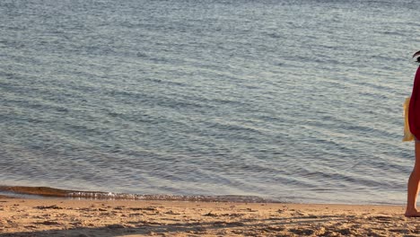 a girl walks along the beach shore