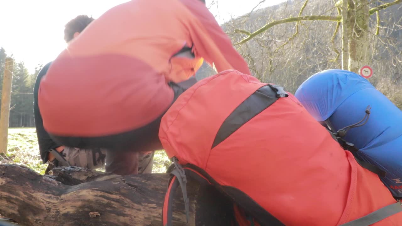 unidentified climber getting ready to hike in the mountains around Creux Du Van, Neuchatel, Switzerland. outdoor activities. equipment for climbing the mountain in cold conditions