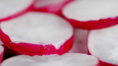 round slices of radish slowly rotate.