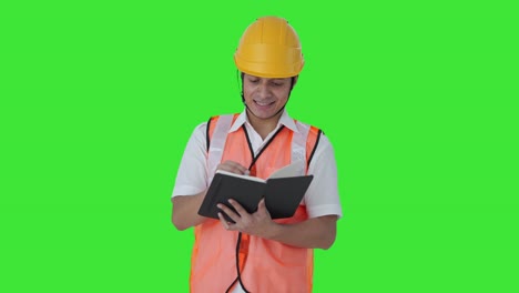 Happy-Indian-architect-writing-down-notes-of-the-building-Green-screen