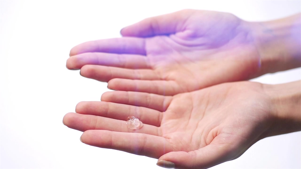 Coronavirus prevention hand sanitiser using alcohol gel for clean hands hygiene corona virus spread prevention. Woman using alcohol rub alternative to washing hands.